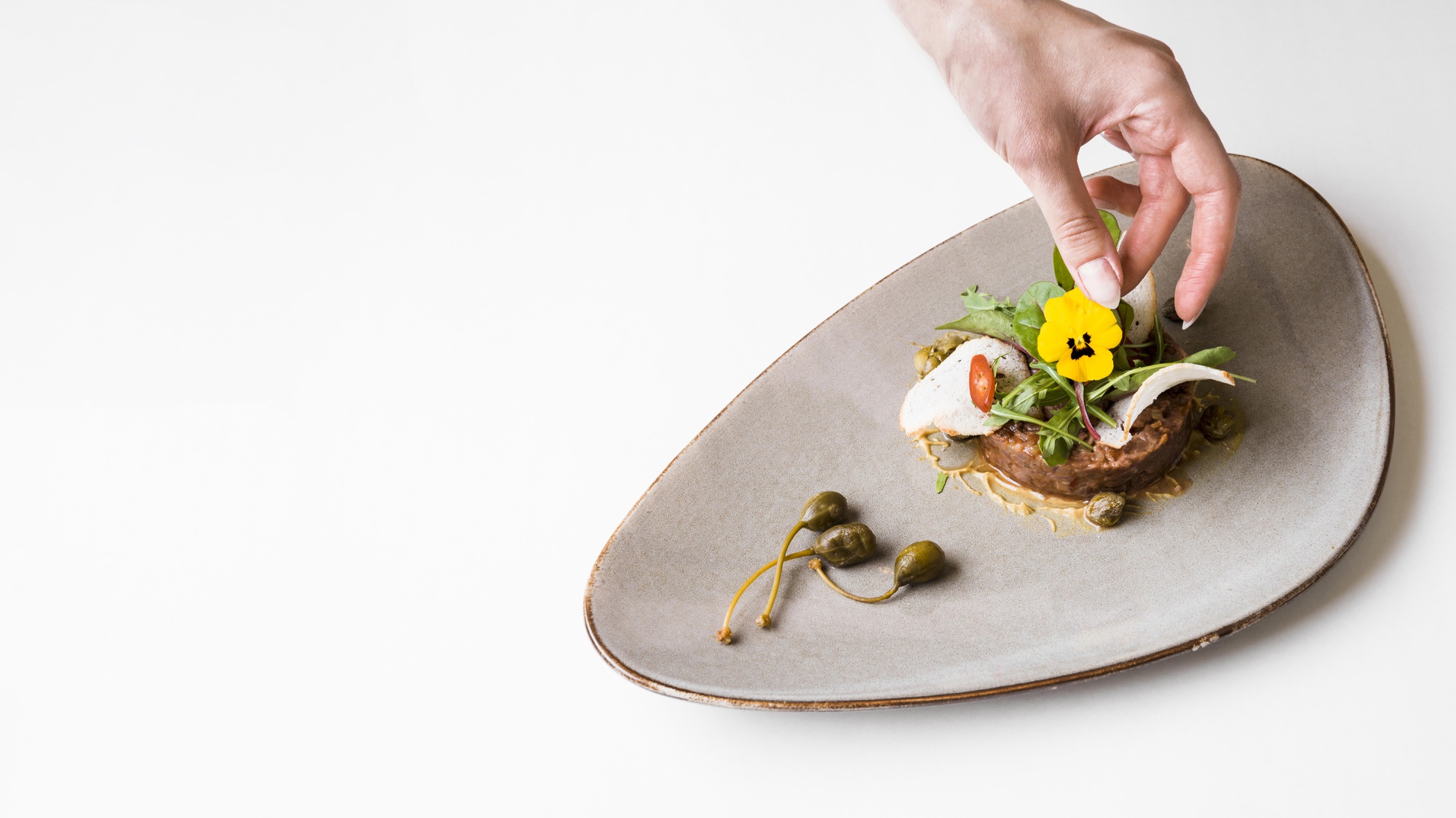 chef preparing plated dish in rustic kitchen